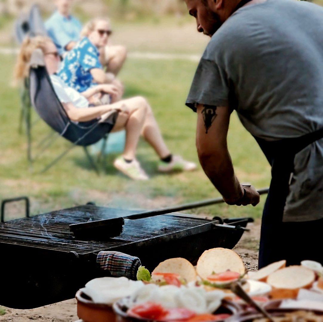A chef preparing the grill outside Cantina Menorca